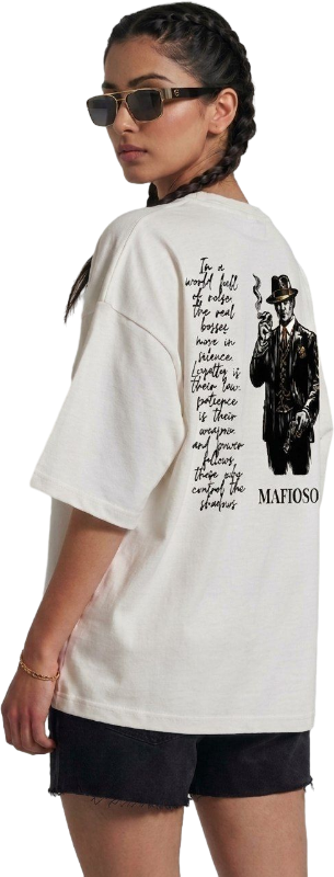 Person wearing a white t-shirt with black text and graphics, standing against a plain background